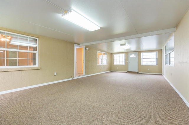 unfurnished room with baseboards and carpet