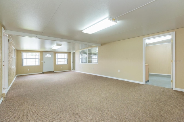 carpeted empty room with baseboards