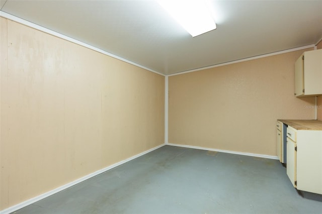 unfurnished room with concrete flooring and baseboards