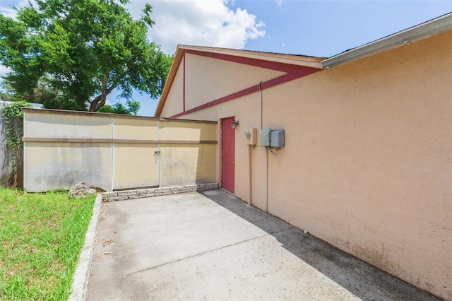 view of side of property featuring stucco siding