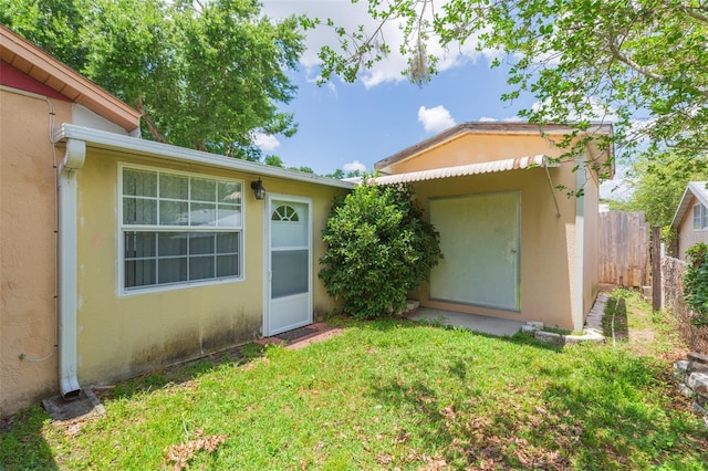 entrance to property featuring stucco siding