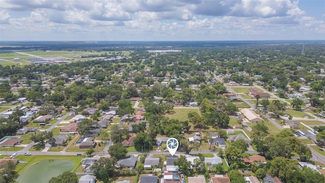 aerial view of property and surrounding area featuring nearby suburban area