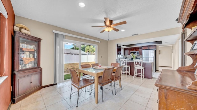 dining room with ceiling fan, light tile patterned floors, recessed lighting, a textured ceiling, and baseboards