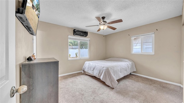 carpeted bedroom with baseboards, a textured ceiling, and a ceiling fan