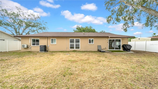 back of house featuring central air condition unit, stucco siding, and ac unit