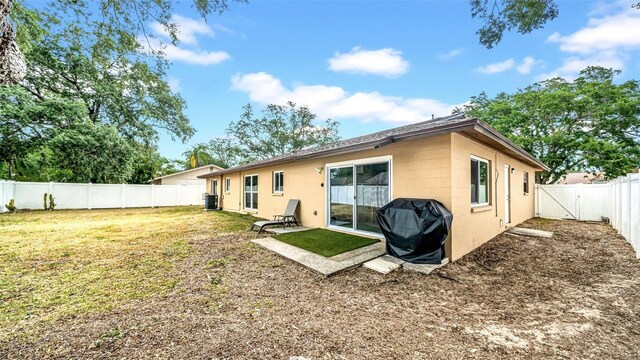 rear view of property featuring concrete block siding