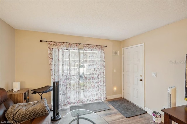 5321 Summerlin Rd Unit 2108, Fort Myers, FL 33919 - foyer entrance with wood finished floors, baseboards, and a textured ceiling
