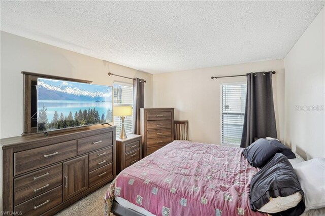 5321 Summerlin Rd Unit 2108, Fort Myers, FL 33919 - bedroom with a textured ceiling and light colored carpet