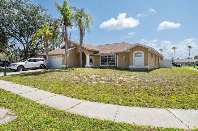 10149 Briar Cir, Hudson, FL 34667 - ranch-style house featuring stucco siding, a garage, and a front yard