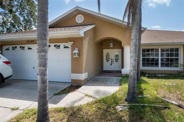 10149 Briar Cir, Hudson, FL 34667 - view of front of property with a garage, driveway, stucco siding, and roof with shingles