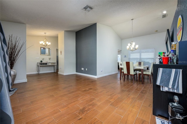 10149 Briar Cir, Hudson, FL 34667 - living area with a chandelier, light wood-style flooring, baseboards, vaulted ceiling, and a textured ceiling