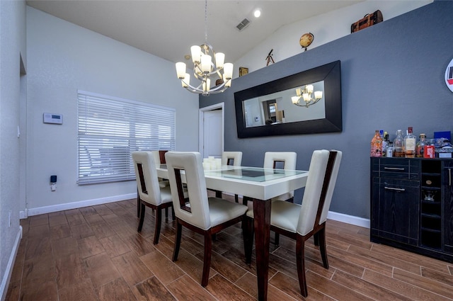 10149 Briar Cir, Hudson, FL 34667 - dining space featuring a chandelier, vaulted ceiling, dark wood finished floors, and baseboards