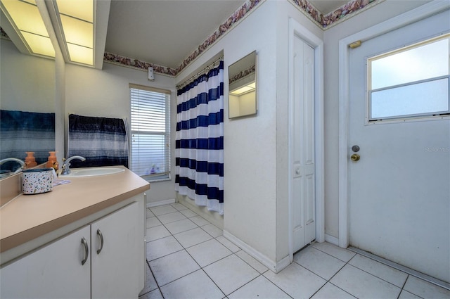 10149 Briar Cir, Hudson, FL 34667 - bathroom with vanity, tile patterned flooring, a shower with curtain, and baseboards