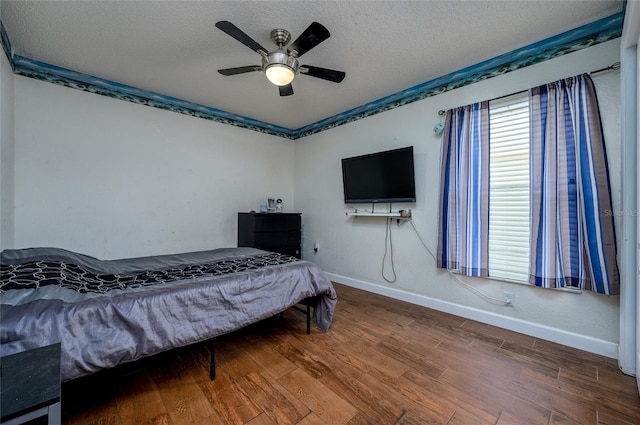 10149 Briar Cir, Hudson, FL 34667 - bedroom with wood finished floors, baseboards, a textured ceiling, and a ceiling fan