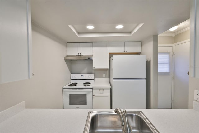 4801 W Mcelroy Ave Unit D104, Tampa, FL 33611 - kitchen with white appliances, under cabinet range hood, light countertops, white cabinetry, and a raised ceiling