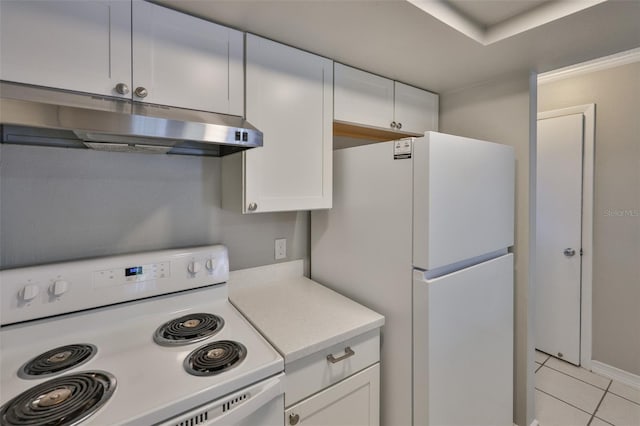 4801 W Mcelroy Ave Unit D104, Tampa, FL 33611 - kitchen featuring white appliances, under cabinet range hood, light countertops, light tile patterned floors, and white cabinets