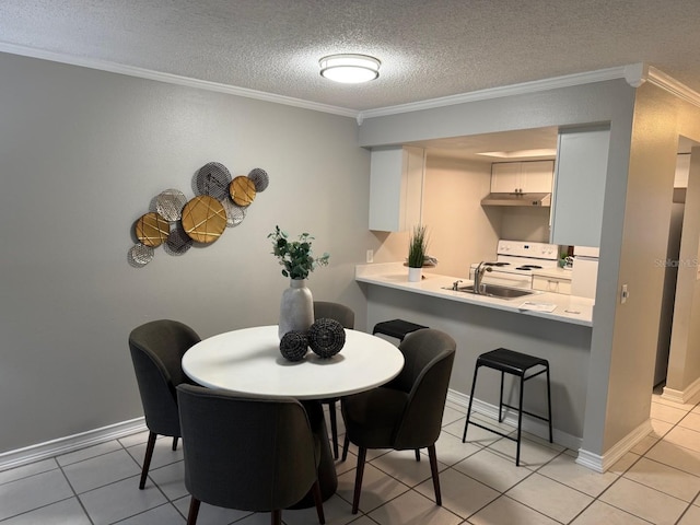 4801 W Mcelroy Ave Unit D104, Tampa, FL 33611 - dining room featuring crown molding, a textured ceiling, light tile patterned floors, and baseboards