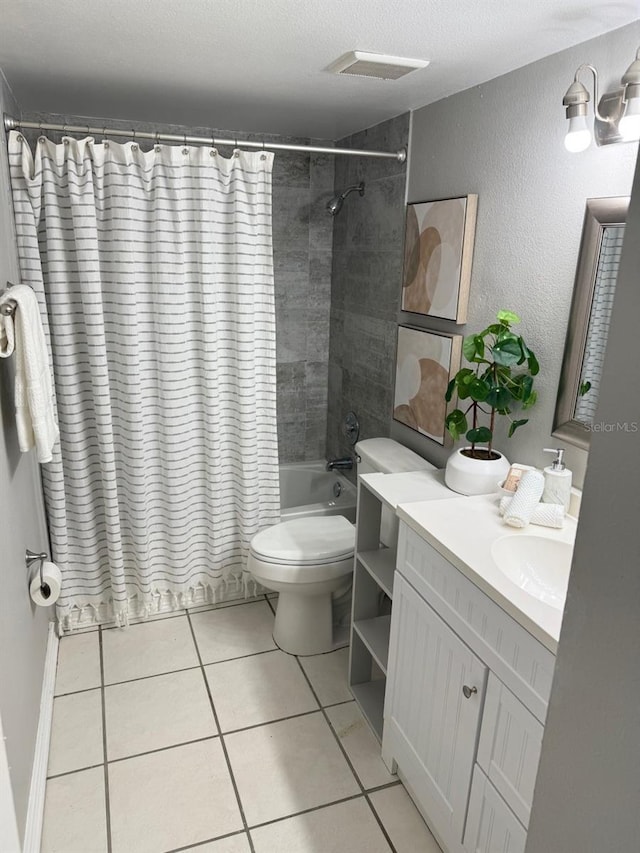 4801 W Mcelroy Ave Unit D104, Tampa, FL 33611 - full bath featuring toilet, vanity, shower / bath combo with shower curtain, tile patterned floors, and a textured wall