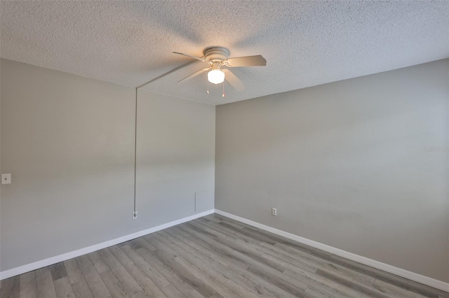 4801 W Mcelroy Ave Unit D104, Tampa, FL 33611 - spare room featuring ceiling fan, wood finished floors, baseboards, and a textured ceiling