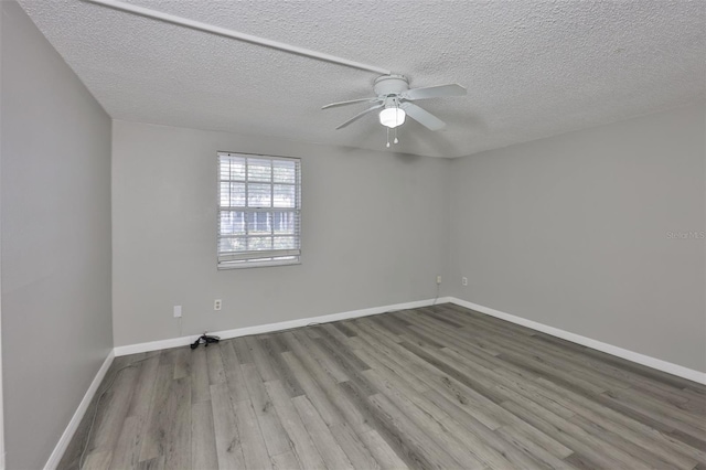 4801 W Mcelroy Ave Unit D104, Tampa, FL 33611 - spare room featuring wood finished floors, a ceiling fan, a textured ceiling, and baseboards
