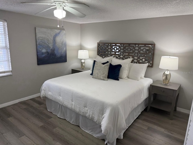 4801 W Mcelroy Ave Unit D104, Tampa, FL 33611 - bedroom featuring wood finished floors, a textured ceiling, baseboards, multiple windows, and ceiling fan