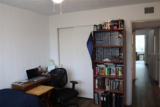 2020 World Parkway Blvd Unit 12, Clearwater, FL 33763 - bedroom with wood finished floors, a desk, and a closet