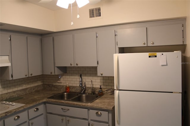 2020 World Parkway Blvd Unit 12, Clearwater, FL 33763 - kitchen with white appliances, a sink, range hood, and backsplash