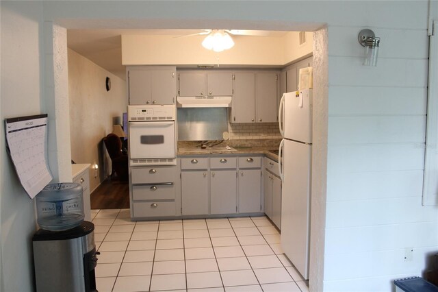 2020 World Parkway Blvd Unit 12, Clearwater, FL 33763 - kitchen with white appliances, under cabinet range hood, gray cabinets, ceiling fan, and light tile patterned floors