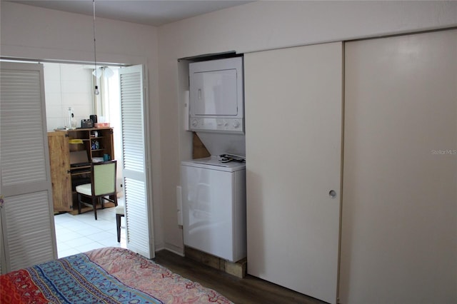 2020 World Parkway Blvd Unit 12, Clearwater, FL 33763 - bedroom with stacked washer and clothes dryer and light wood finished floors