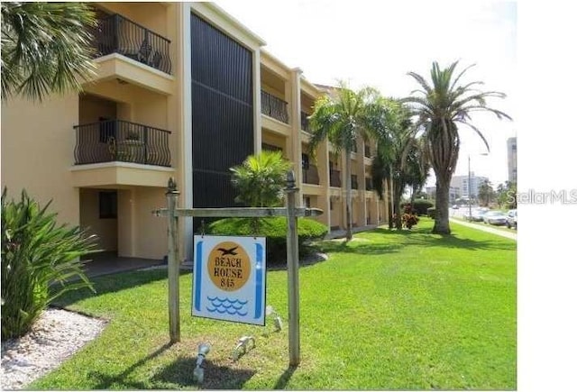view of home's community with a lawn