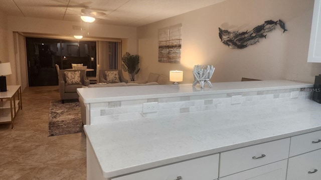 kitchen with white cabinets, light countertops, and light tile patterned floors
