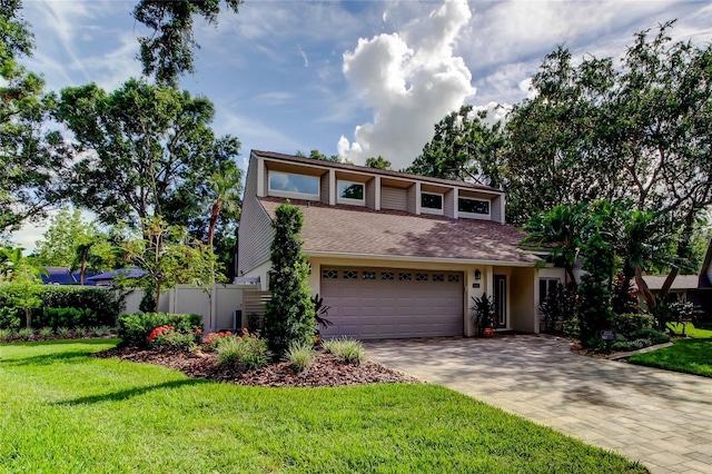 3406 Hollyhock Way, Tampa, FL 33618 - view of front of property featuring driveway, a garage, stucco siding, and roof with shingles