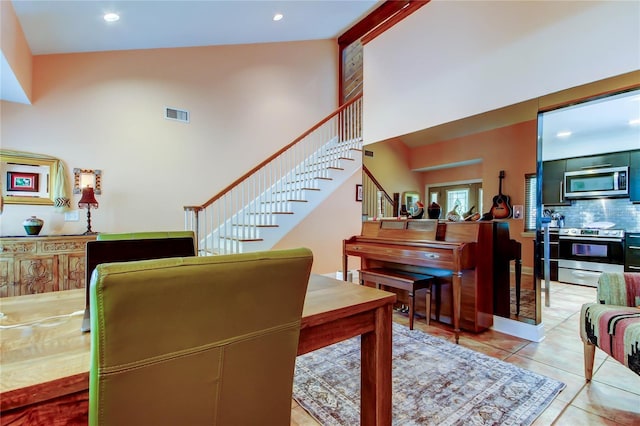 3406 Hollyhock Way, Tampa, FL 33618 - staircase featuring tile patterned floors, a towering ceiling, and recessed lighting