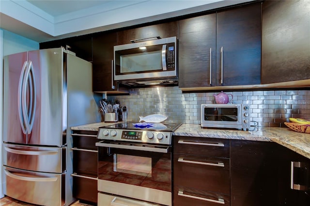 3406 Hollyhock Way, Tampa, FL 33618 - kitchen with stainless steel appliances, decorative backsplash, dark brown cabinets, and light stone countertops