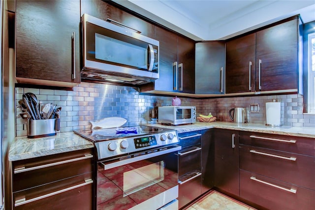 3406 Hollyhock Way, Tampa, FL 33618 - kitchen with appliances with stainless steel finishes, light stone countertops, backsplash, and dark brown cabinets