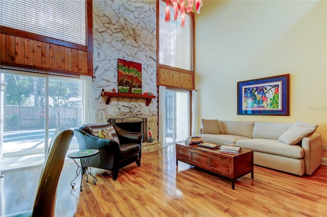 3406 Hollyhock Way, Tampa, FL 33618 - living area featuring a towering ceiling, light wood-style flooring, healthy amount of natural light, and a fireplace