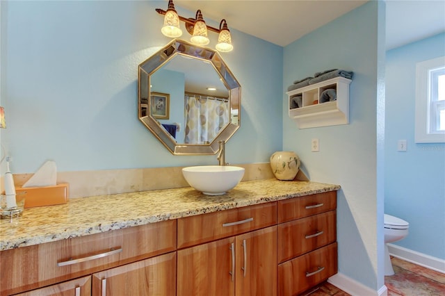 3406 Hollyhock Way, Tampa, FL 33618 - full bathroom with toilet, vanity, and baseboards