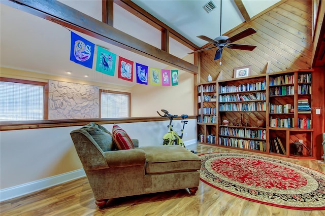 3406 Hollyhock Way, Tampa, FL 33618 - living area featuring baseboards, wood finished floors, a ceiling fan, healthy amount of natural light, and wood walls