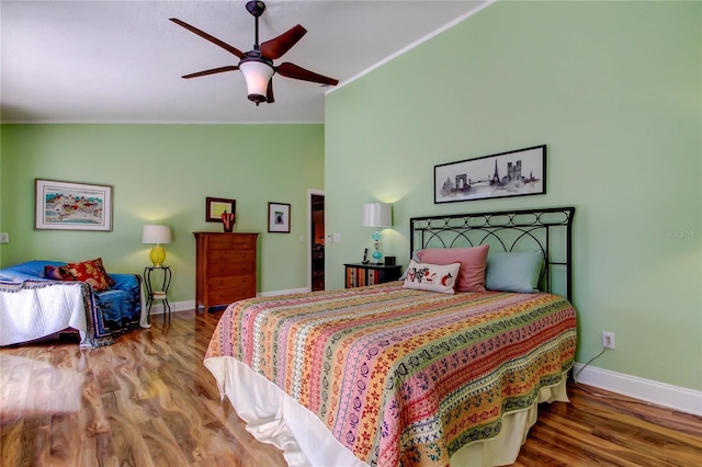 3406 Hollyhock Way, Tampa, FL 33618 - bedroom with baseboards, wood finished floors, vaulted ceiling, crown molding, and ceiling fan