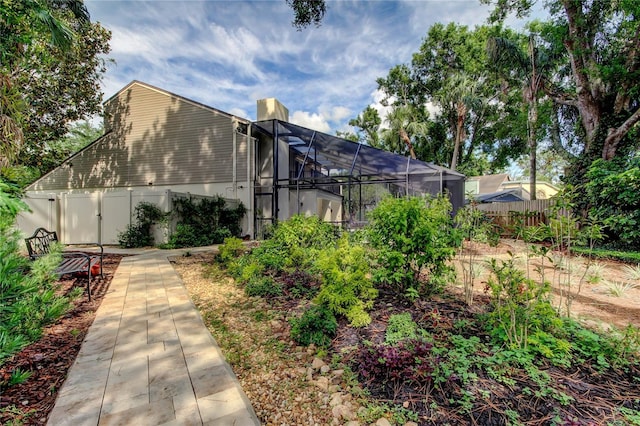 3406 Hollyhock Way, Tampa, FL 33618 - view of yard featuring fence, glass enclosure, and a gate