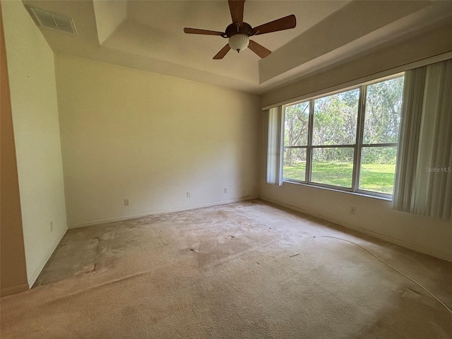 2846 N Kittery Pt, Hernando, FL 34442 - spare room featuring a raised ceiling, carpet floors, a ceiling fan, and baseboards