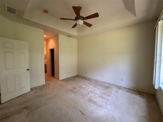 2846 N Kittery Pt, Hernando, FL 34442 - unfurnished bedroom featuring a tray ceiling, light colored carpet, baseboards, and a ceiling fan