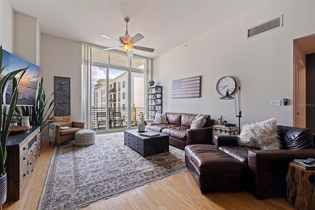 1208 E Kennedy Blvd Unit 831, Tampa, FL 33602 - living area with floor to ceiling windows, a ceiling fan, and light wood-type flooring