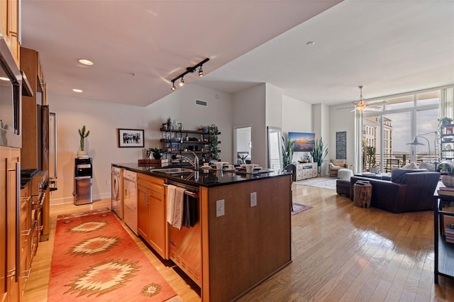 1208 E Kennedy Blvd Unit 831, Tampa, FL 33602 - kitchen featuring a sink, dishwasher, light wood-style floors, open floor plan, and ceiling fan