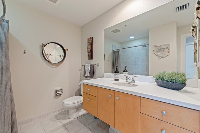 1208 E Kennedy Blvd Unit 831, Tampa, FL 33602 - full bathroom featuring tile patterned floors, toilet, a tile shower, vanity, and baseboards