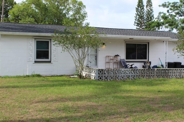 4928 Lake Ridge Ln, Holiday, FL 34690 - rear view of property with a yard and a shingled roof
