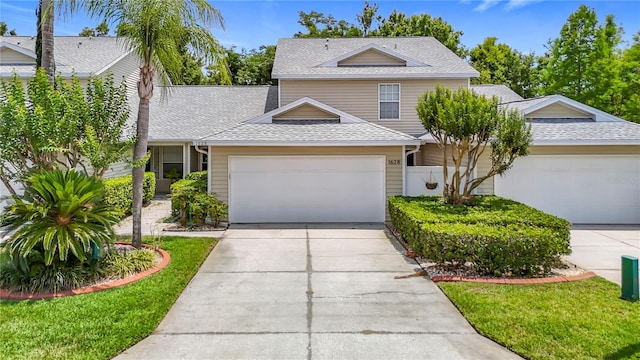 1628 Lullwater Ln, Lutz, FL 33549 - traditional-style house with concrete driveway, a garage, and roof with shingles
