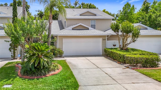 1628 Lullwater Ln, Lutz, FL 33549 - view of front of home featuring roof with shingles, concrete driveway, and an attached garage