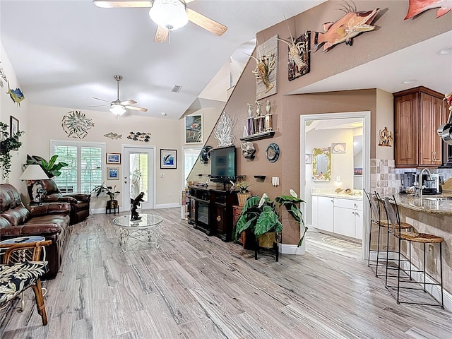 1628 Lullwater Ln, Lutz, FL 33549 - living area with ceiling fan, light wood-type flooring, high vaulted ceiling, and baseboards