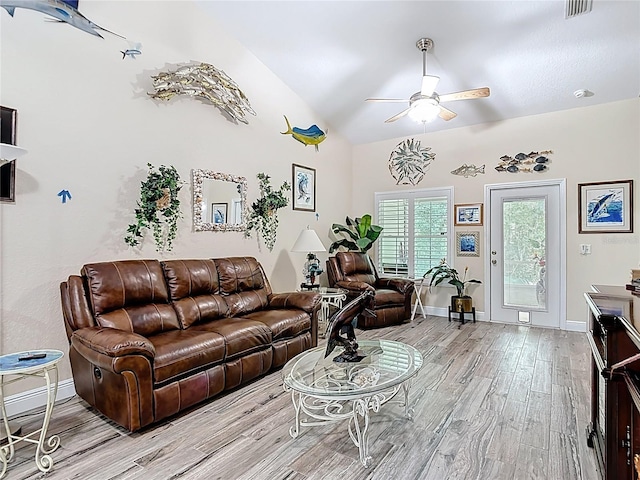1628 Lullwater Ln, Lutz, FL 33549 - living area with wood finished floors, ceiling fan, baseboards, and vaulted ceiling